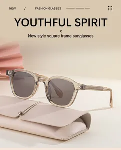 Detail of square grey sunglasses with transparent frame and beige leather case