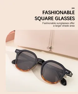 Detail of square sunglasses with black and amber frames and metallic rivet accents