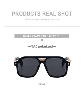 Close-up of square black polarized sunglasses with gold metal bridge and side rivet details