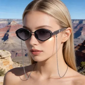 Close-up of geometric polygon sunglasses with metal chain and purple gradient lenses