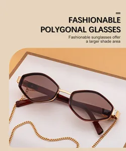 Close-up of polygon sunglasses with tortoise frame and gold chain link accessory