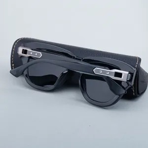 Detail of polarized sunglasses with silver metal hinge and lychee leather case