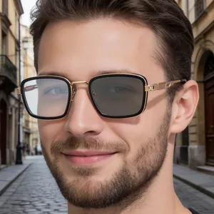 Detail of square photochromic sunglasses with gold metal temples and hinges on a male model