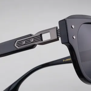 Detailed close-up of premium metal hinge and golden model ID on black eyewear frames