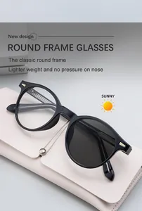 Detail of round black sunglasses with photochromic lenses and gold rivet accents