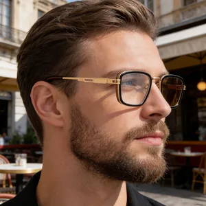 Close-up of retro square black and gold sunglasses with embossed metal temples on male model