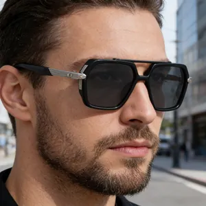 Detail of male model wearing square frame sunglasses with silver metal temple accents
