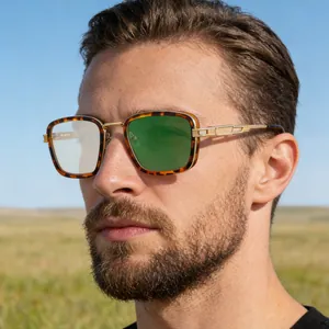 Detail of vintage square frame sunglasses with gold temples on male model in sunlight