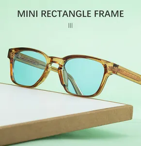 Close-up of mini rectangle sunglasses with amber frames and light blue lenses
