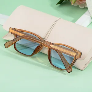 Detail of tortoise shell square sunglasses with blue lenses and engraved metal core wire