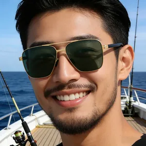 Detail of square polarized sunglasses for men with golden metal frame in sea scenery