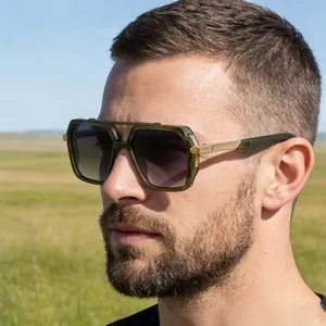 Close-up of square pilot sunglasses with dark green acetate frame and gold metal temples