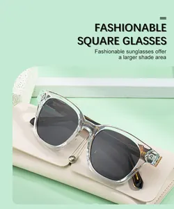 Detail of square sunglasses with gold Greek key metal hinges and leather folding case