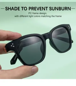 Detail of square black sunglasses showing 3-point rivets and golden metal hinge accents