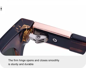 Macro detail of sturdy metal hinge and amber tortoiseshell frame on fashion sunglasses