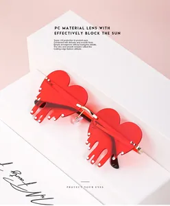 Detail of red heart sunglasses with dripping edge design and white micro-bead accents