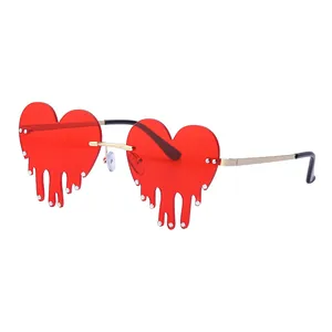 Fashionable melting heart sunglasses with red lenses, gold frames and silver rhinestones