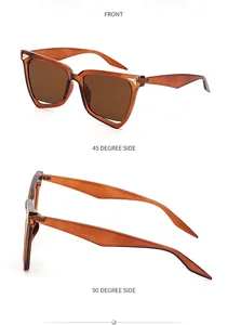 Dettaglio occhiali da sole cat-eye con montatura marrone e borchie in metallo dorato