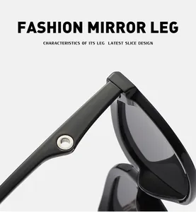Detailed view of black cat-eye sunglasses with silver metal ring on the thin temple arm