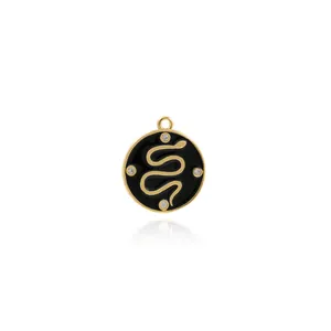 Macro detail of 18K gold-plated snake charm with black enamel and four zircon accents