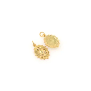 Detail of 18K gold-plated oval Sacred Heart pendants showing front relief and matte back