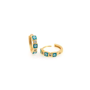 Detail of 18K gold-plated huggie earrings with evil eye enamel and cubic zirconia