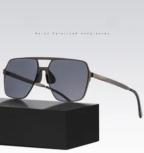 Close-up of polarized nylon lenses and double-bridge metal frame on square sunglasses