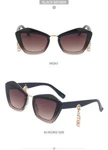 Vues détaillées de lunettes de soleil œil-de-chat noires avec charnières dorées et pendentifs m