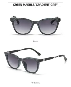 Detail view of cat-eye sunglasses with green marble frame and gradient grey lenses