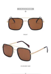 Detail view of square double-bridge sunglasses with gold metal frame and black-brown lenses