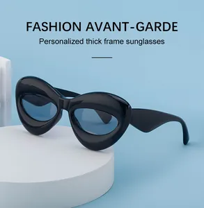 Detail view of bold black thick frame sunglasses with edgy avant-garde design aesthetics