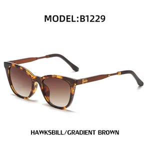 Cat eye tortoiseshell sunglasses with gradient brown lenses and golden metal accents