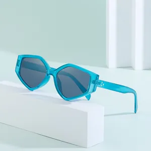 Polygonal oversized sunglasses with translucent teal frames and grey lenses for women
