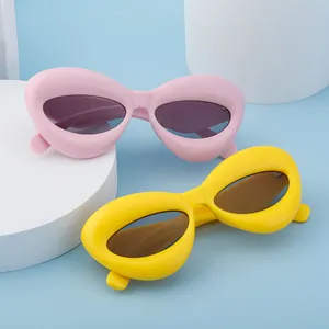 Chic inflated wide frame sunglasses in pink and yellow with dark UV lenses