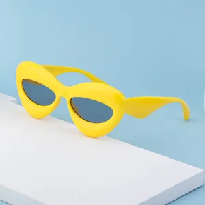 Chunky yellow oversized sunglasses with round avant-garde frames and dark lenses