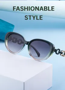 Macro view of green cat eye sunglasses with thick resin chain temples and metal swan logo