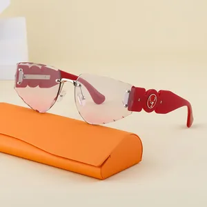 Frameless gradient pink sunglasses with red temples and gold stag logo on orange case