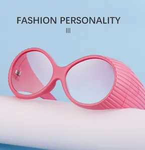 Detail of pink oval oversized sunglasses with wide side shields on white display
