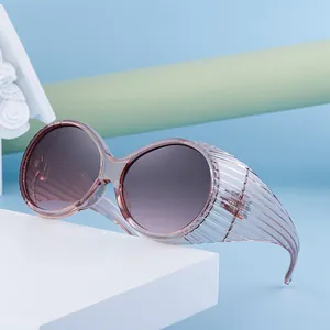 Oversized oval sunglasses with translucent pink frames and purple gradient lenses