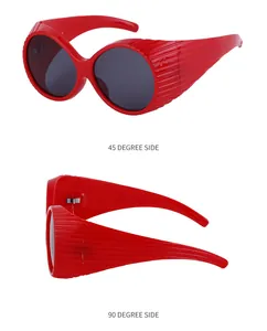 Detailed side view of red oversized oval sunglasses with unique vertical stripe temples
