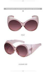 Detail of oversized oval sunglasses with transparent brown frame and gradient lenses