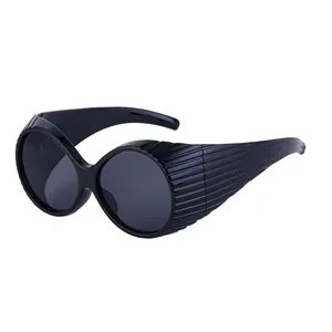 Fashionable oversized oval sunglasses in black with unique textured stripe temples for women
