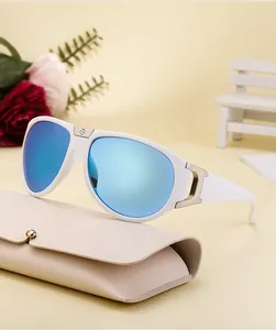 Close-up of white sports sunglasses with blue mirrored lenses on a beige leather case