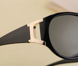Close-up of golden geometric metal hinges on high-quality black fashion sunglasses