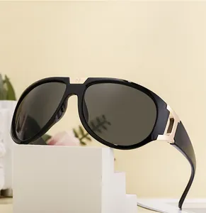 Detail of sports sunglasses with black frame and golden metal logo on the bridge