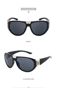 Close-up of polarized black sunglasses with golden metal accents and gray lenses