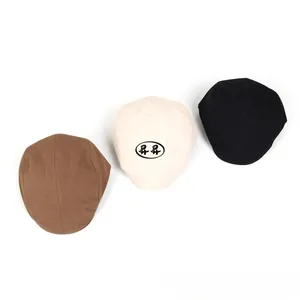 Close-up of classic cotton linen flat caps in brown, beige, and black colors