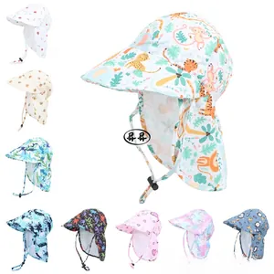Detail of baby sun hat with neck flap featuring cartoon prints and adjustable chin strap