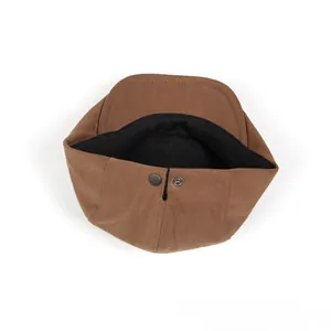 Close-up of brown cotton linen beret inner lining with adjustable metal buckle back