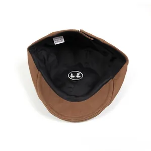 Detail view of cotton ivy cap interior showing a 100% cotton tag and black lining